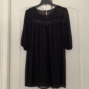 Black dress. Lined with sheer overlay.